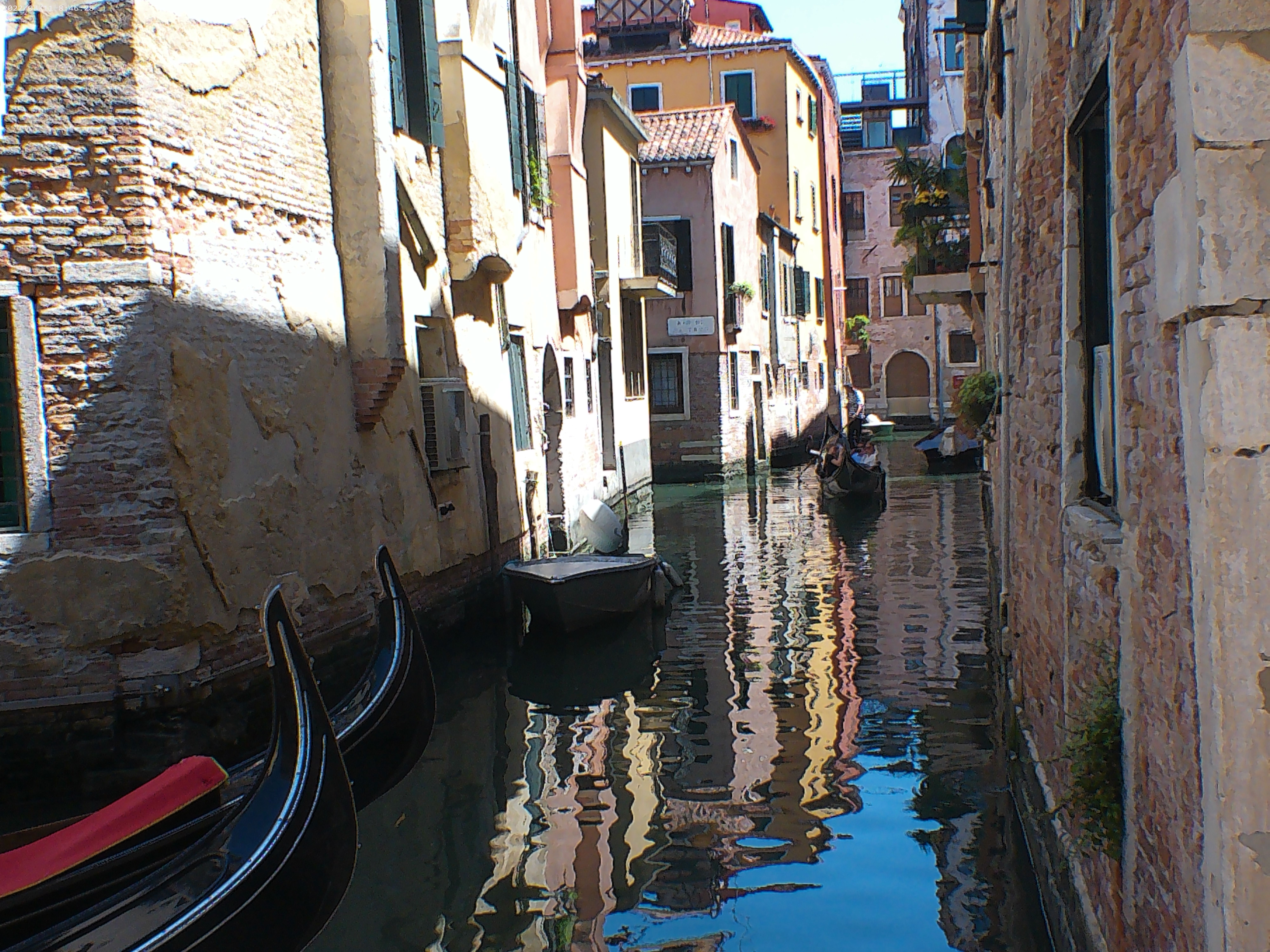 A picture looking down a canal with gondolas