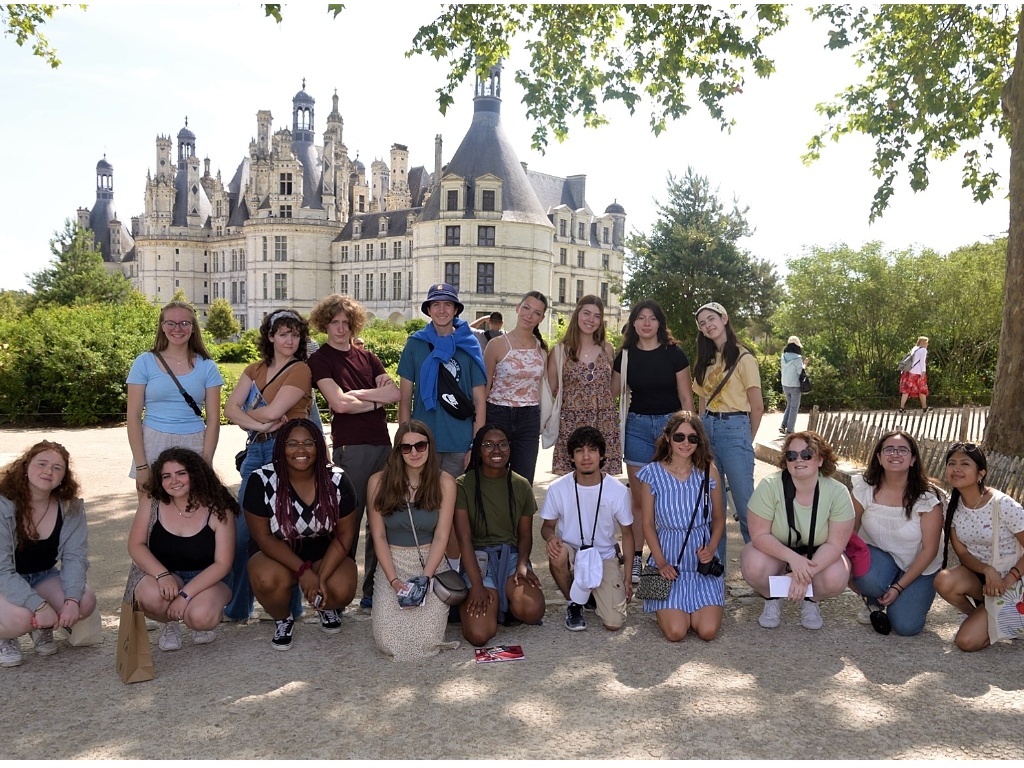 A group of students pose in front of French chateau