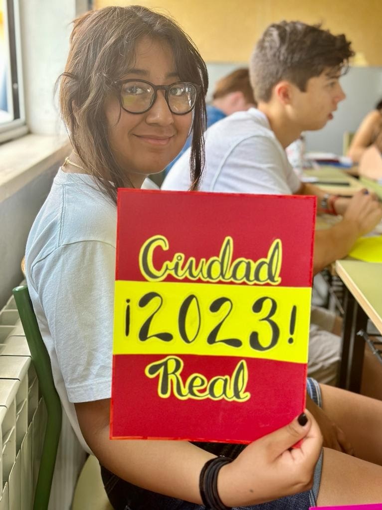 A student holds a sign that reads Ciudad Real 2023